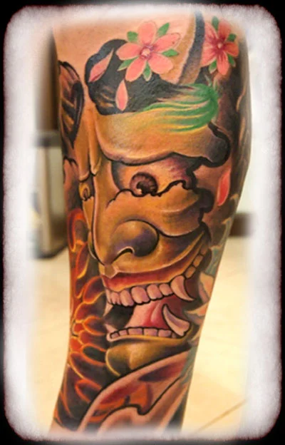 Colourful Japanese-inspired mask tattoo